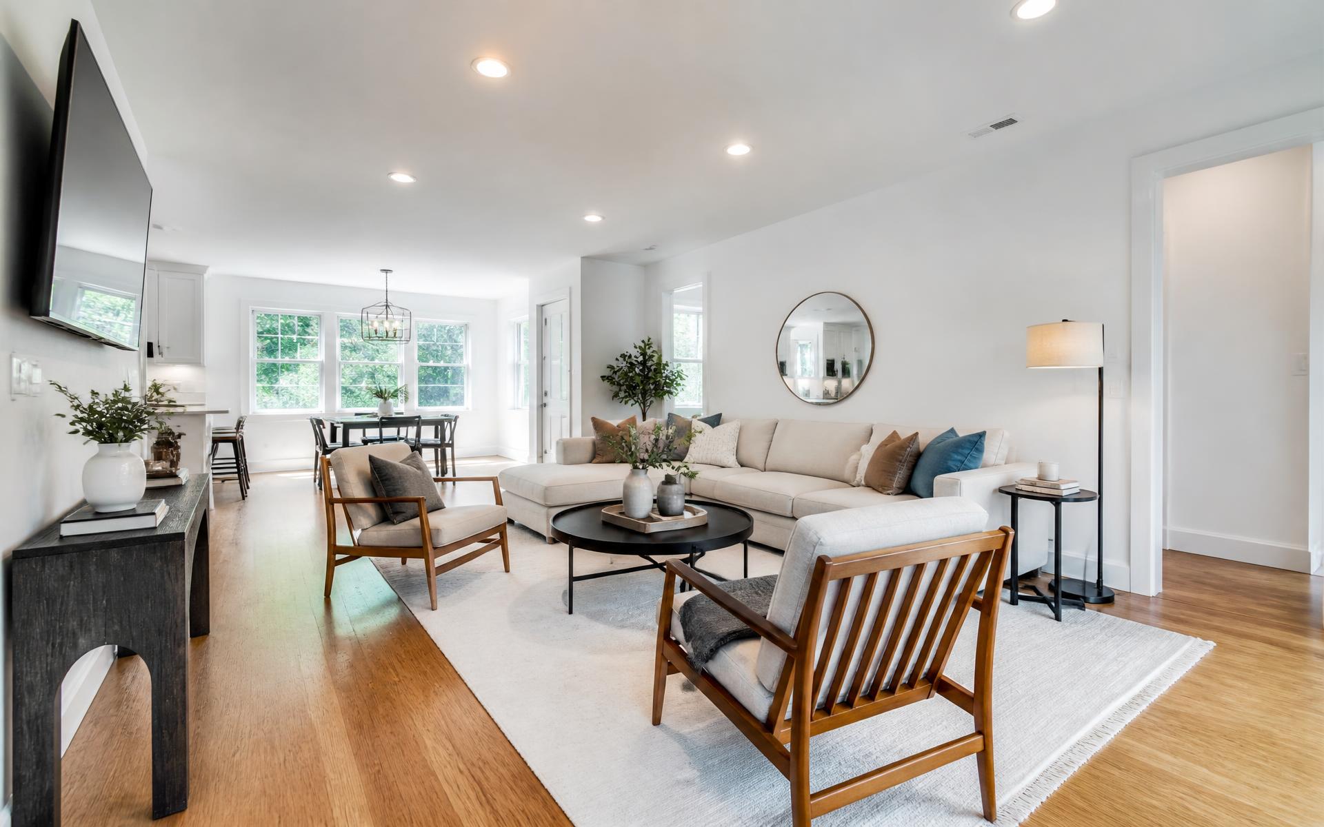 Renovated living room with new hardwood flooring and freshly painted walls